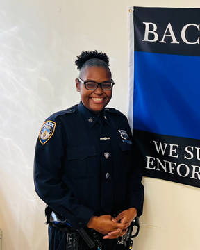 Hospital Police Officer Desir posted by law enforcement flag.