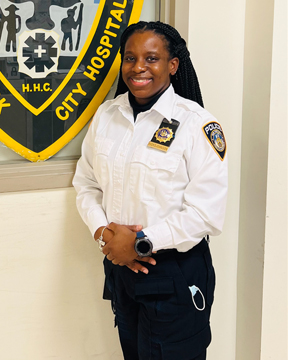 Lt. Hicks-Johnson standing by hospital police decal.