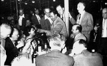 “Once a year we had a meeting at the Hotel Diplomat. We would have libations plus a little food and an entertainer,” John Hartter said. Holding the microphone for the accordionist/singer is Joe Muratore, who broke Hartter in when be was first hired by the Water Dept. Others identified are John O’Rourke (left), Jerry Herel (at the left of the pole), John Fiorillo (lower left), and Bill Norton (holding the pole), another of Hartter’s partners